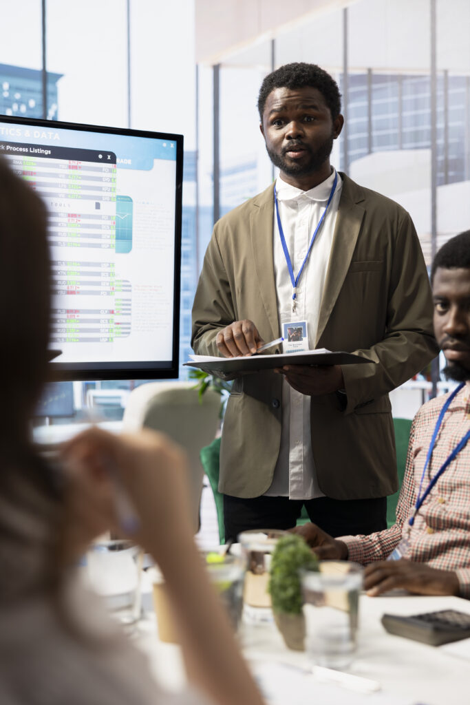 african american ceo leads a corporate briefing meeting with the shareholders